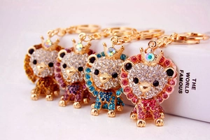 Macro shot of rhinestone lion keychains in gold, purple, blue, and pink finishes