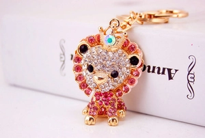 Macro shot of the golden lion keychain with sparkling pink rhinestones and a small crown