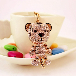 Charming golden tiger keychain with sparkling white rhinestones and black enamel stripes