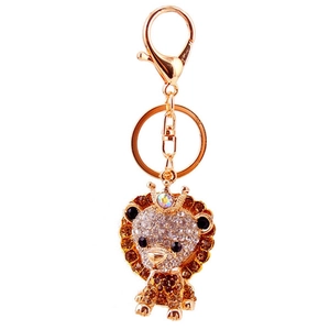 Detail shot of a luxury crown lion keychain with brown and white sparkling rhinestones