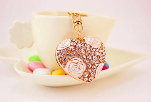 Detail view of heart keychain with gold alloy rose and sparkling crystal rhinestones