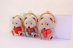 Detailed row of three rhinestone teddy bear charms in red, blue and pink colors