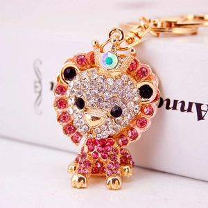 Creative rhinestone lion keychain with crown and sparkling pink crystals in gold finish