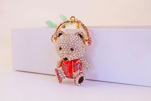 Close-up of sparkling crystal teddy bear keychain with pink rhinestones and red scarf detail