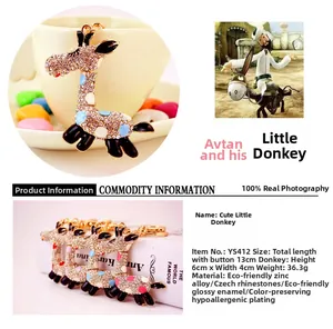 Detail showing enamel donkey keychain with sparkling rhinestones and a polished gold clasp