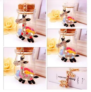 Macro detail of giraffe keychains featuring sparkling rhinestones and colorful enamel dots