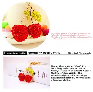 Close-up of red rhinestone cherry keychain with gold-plated hollow leaf details