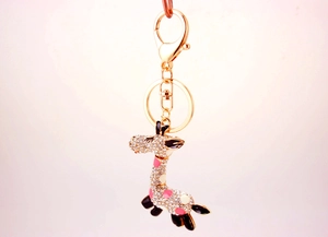 Detailed close-up of a giraffe keychain featuring crystal rhinestones and enamel accents