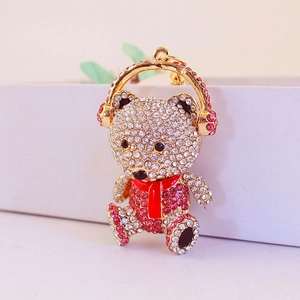 Cute teddy bear keychain with pink rhinestones and gold headphones accessory
