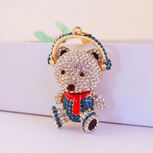 Cute teddy bear keychain with blue crystal headphones and red scarf in gold plating