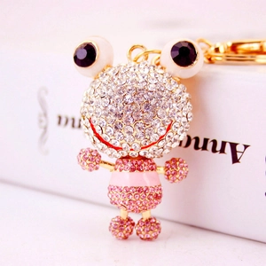 Porte-clés grenouille doré orné de strass blancs et roses étincelants avec de grands yeux