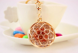 Detailed close-up of a hollow flower keychain with rhinestones and a lobster clasp