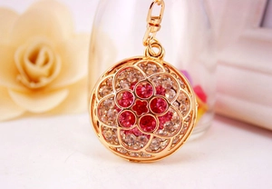 Macro shot of gold floral keychain with pink and white rhinestones and lobster clasp