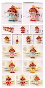 Detailed close-up of crystal-encrusted monkey keychains with crowns in multiple vibrant colors