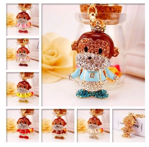 Detail view of 7 colorful crystal monkey keychains with crowns and sparkling rhinestones