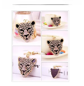 Detail of crystal leopard head keychain with gold-plated finish and leather back