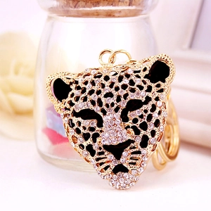 Golden leopard head keychain with sparkling rhinestones and black enamel eye accents