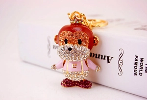 Close-up of cute cartoon monkey keychain encrusted with shiny colorful rhinestones