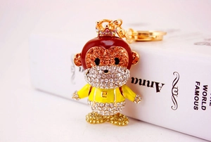 Detail of crystal-encrusted monkey keychain with gold plating and crown accent