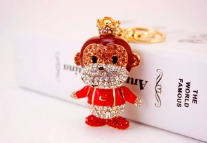 Detail of crystal zodiac monkey keychain featuring golden metal crown and sparkling rhinestones
