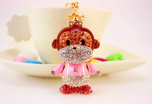 Close-up of a crystal monkey keychain with letter E and colorful rhinestone details