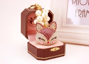 Detailed fox keychain with pink rhinestones and pearl bead in a luxury gift box