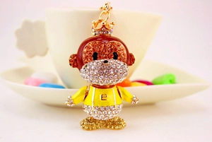 Close-up of cute monkey keychain with sparkling rhinestones and golden crown detail