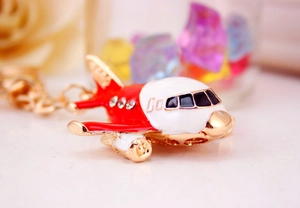 Gros plan détaillé d'un porte-clés avion A380 rouge et blanc avec strass et placage doré