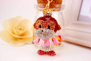 Macro shot of colorful rhinestone monkey keychain with gold plating and crown clasp
