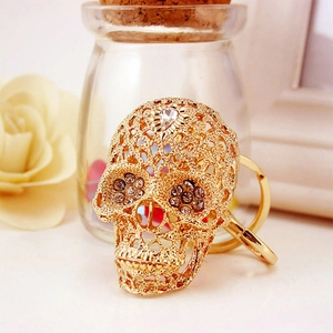 Golden hollow skull keychain with sparkling crystals and fine metal craftsmanship details