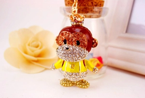 Macro shot of cartoon monkey keychain featuring sparkling crystal rhinestones detailing