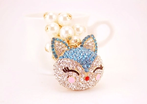 Detailed close-up of a fox-shaped keychain with rhinestones and faux pearls on white base