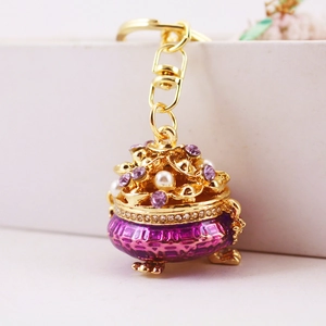 Luxurious gold incense burner keychain with purple crystals and pearl embellishments
