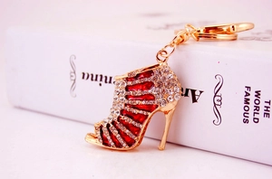 Macro shot of red enamel stiletto keychain with rhinestones and gold metal base