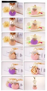 Detail of beaded pearl handbag keychains with rhinestones in purple and champagne colors