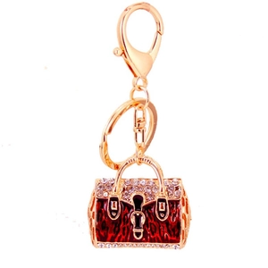 Exquisite rhinestone handbag keychain with red leopard enamel and gold-plated finish