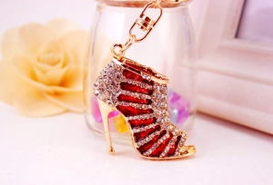 Detailed close-up of red enamel high heel keychain with sparkling rhinestones and gold lobster clasp