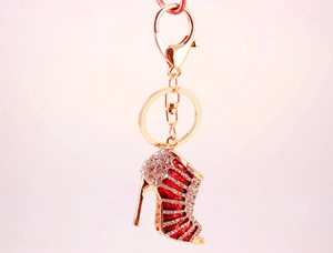 Detailed view of rhinestone high heel keychain with red enamel and gold-plated alloy