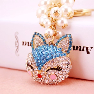 Light blue crystal fox head keychain with pearl tassels and gold plated ring