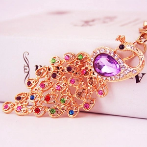 Colorful crystal peacock keychain with purple rhinestone set in gold plated metal finish