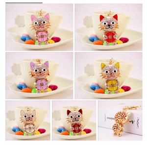 Detailed grid view of crystal rhinestone cat keychains in pink, red, and purple colors