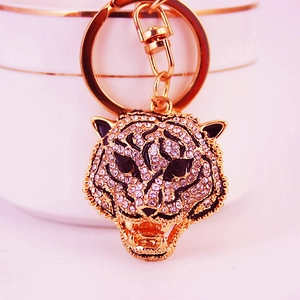 Golden tiger head keychain with sparkling rhinestones and black enamel accents