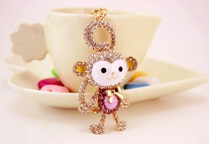 Close-up of golden monkey keychain with crystal rhinestones and enamel face detail