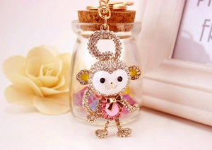 Detailed view of monkey keychain with sparkling rhinestones and golden enamel finish