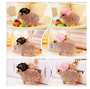 Detailed close-up of sparkling rhinestone sheep keychain with gold metal and enamel finish
