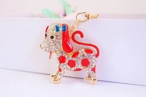 Detail of cute dalmatian puppy keychain with crystal rhinestones and blue bow charm