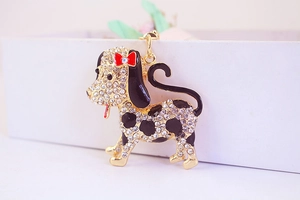 Detailed view of spotted dog keychain with sparkling rhinestones and black enamel