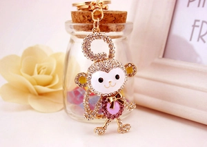 Macro detail of crystal rhinestone monkey keychain with gold plating and enamel finish