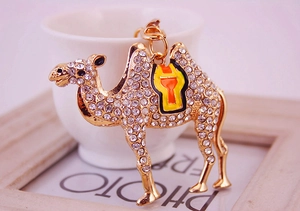 Detailed view of camel keychain with white rhinestones and yellow orange enamel work