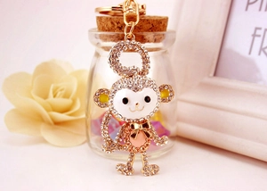 Close-up of crystal monkey keychain with detailed sparkling rhinestones and pink enamel finish